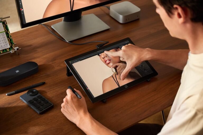 XPPen Artist Ultra 14 OLED drawing display being used with its stylus at a desk